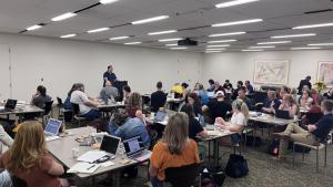 Students in classroom listening to presenter