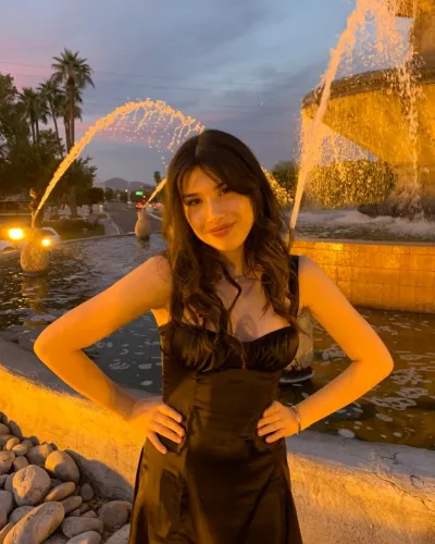 Amanda Juvera standing in front of large water fountain